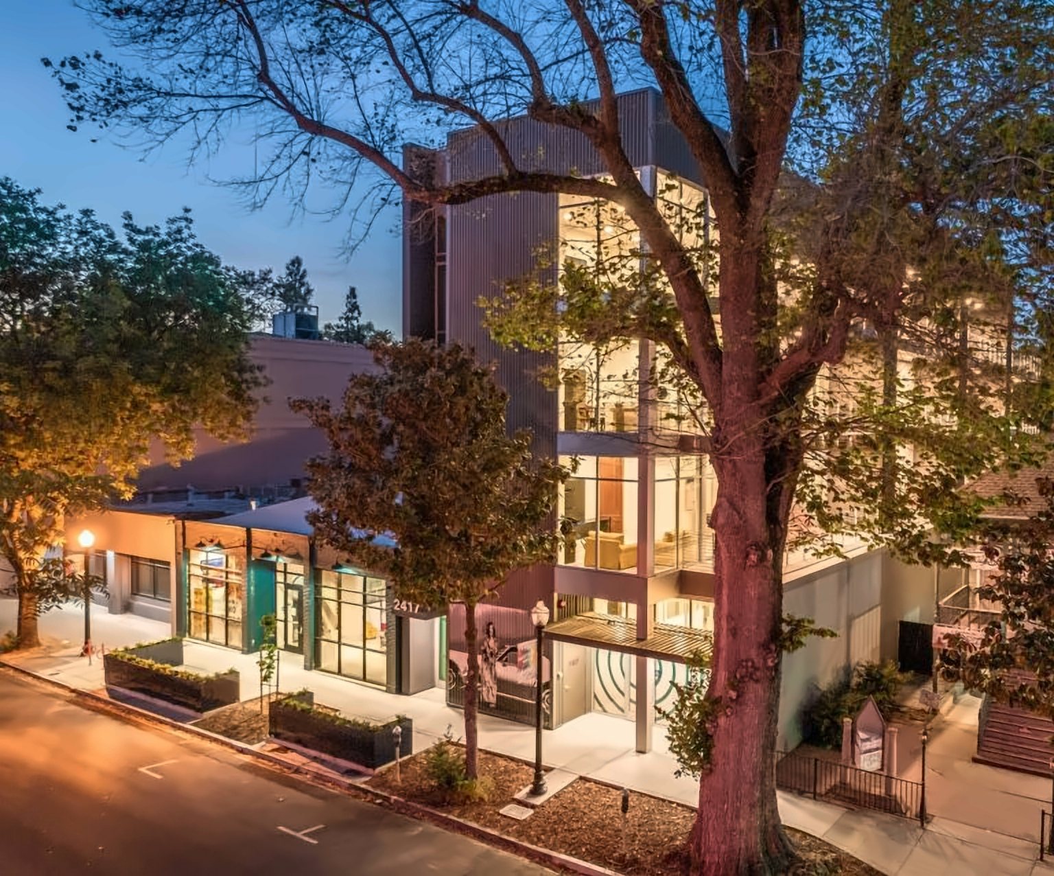 Three-story mixed-use building at dusk